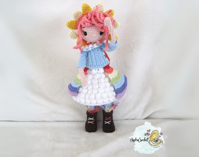 Crocheted rainbow fairy doll with sun-shaped hair and a colorful layered outfit made using Scheepjes Catona yarn